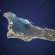 The island of Grand Cayman, a British dependency that covers 76 square miles (197 square kilometers) in the northwest Caribbean Sea, is visible in this near-vertical photograph. Geologically similar to The Bahamas, Grand Cayman is a low-lying, limestone island located on top of a submarine ridge. The city of George Town, the capital and chief port of the Cayman Islands, can be seen at the southwest end of the island. Grand Cayman’s 7-mile beach can be seen on the western side of the island.
